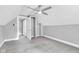Bedroom featuring neutral walls, carpet, and doorway to a hallway with two doorways at 247 N 14Th St, Noblesville, IN 46060