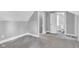 Bedroom featuring neutral walls, carpet, and doorway to the bathroom with a toilet and sink at 247 N 14Th St, Noblesville, IN 46060