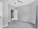 Bedroom featuring neutral walls, gray carpet, a ceiling fan, and a view into the adjacent bedroom at 247 N 14Th St, Noblesville, IN 46060