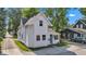 Charming white two-story home with a blue front door and manicured landscaping under a sunny sky at 247 N 14Th St, Noblesville, IN 46060