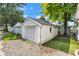 Detached one car garage with white siding and doors on a gravel driveway and a patch of lawn at 247 N 14Th St, Noblesville, IN 46060