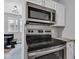 Modern kitchen features stainless steel appliances and white cabinetry at 247 N 14Th St, Noblesville, IN 46060