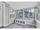 Bright sun room featuring large windows, modern flooring, and a cozy seating area, perfect for relaxation at 247 N 14Th St, Noblesville, IN 46060