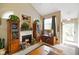 Cozy living room with fireplace, carpeted floor, and a large window providing natural light and an inviting atmosphere at 255 Bastion Pl # Apt D, Avon, IN 46123