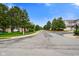 A well-maintained street view showcases the community, lined with mature trees and manicured landscaping at 255 Bastion Pl # Apt D, Avon, IN 46123