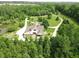 Scenic aerial view of an estate with a private driveway, mature trees, and a serene pond at 2825 E 216Th St, Cicero, IN 46034