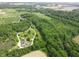 Stunning aerial view of a secluded home surrounded by lush greenery and a winding driveway at 2825 E 216Th St, Cicero, IN 46034