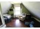 Bright and airy attic space with hardwood floors, large window, and cozy seating at 2825 E 216Th St, Cicero, IN 46034