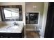 Modern bathroom featuring granite countertops, vanity mirror, and stacked washer and dryer at 2825 E 216Th St, Cicero, IN 46034