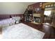 Cozy bedroom featuring hardwood floors, a fireplace, and a view of the kitchen at 2825 E 216Th St, Cicero, IN 46034