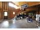 The unfinished garage has tall ceilings with a basketball hoop, offering space with access to a staircase at 2825 E 216Th St, Cicero, IN 46034