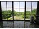 A window view showcases the lush greenery and the serene pond on the property, highlighting the home's peaceful setting at 2825 E 216Th St, Cicero, IN 46034