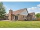 Spacious backyard features mature trees, brick exterior, patio area at 3430 Whalen Ave, Indianapolis, IN 46227