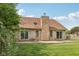 Brick home exterior with backyard featuring mature trees, patio at 3430 Whalen Ave, Indianapolis, IN 46227