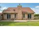Large backyard featuring mature trees, patio, and brick exterior at 3430 Whalen Ave, Indianapolis, IN 46227