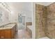 Bright bathroom featuring a granite-top double vanity, a tub, and a walk-in shower at 3430 Whalen Ave, Indianapolis, IN 46227