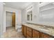 Bright bathroom featuring a double vanity with granite countertops, a toilet, and a walk-in closet at 3430 Whalen Ave, Indianapolis, IN 46227