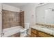 Bathroom features a shower-tub combo, granite vanity, and large mirror at 3430 Whalen Ave, Indianapolis, IN 46227