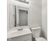Bathroom with updated vanity, mirror, and toilet at 3430 Whalen Ave, Indianapolis, IN 46227