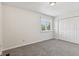Inviting bedroom with plush carpeting, a window view, and a double door closet at 3430 Whalen Ave, Indianapolis, IN 46227