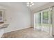 Sunny dining area with tile floor, sliding glass door to backyard, and granite countertops at 3430 Whalen Ave, Indianapolis, IN 46227