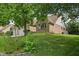 Charming brick home nestled on a lush, green lawn and mature trees at 3430 Whalen Ave, Indianapolis, IN 46227