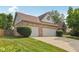 Lovely brick home featuring a three-car garage, well-maintained lawn and tasteful shrubbery at 3430 Whalen Ave, Indianapolis, IN 46227