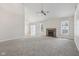 Spacious living room featuring neutral carpet, fireplace, ceiling fan, and lots of natural light at 3430 Whalen Ave, Indianapolis, IN 46227