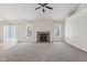 Expansive living room featuring neutral carpet, sliding glass door, fireplace, and lots of natural light at 3430 Whalen Ave, Indianapolis, IN 46227
