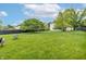 Spacious backyard with a lush lawn, mature trees, privacy fence, and outdoor seating area at 3637 Newberry Rd, Plainfield, IN 46168