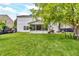 Expansive backyard featuring a screened-in porch, mature trees, and lush green lawn at 3637 Newberry Rd, Plainfield, IN 46168
