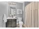 Well-maintained bathroom with a classic vanity, decorative mirror, and convenient shower curtain at 3637 Newberry Rd, Plainfield, IN 46168