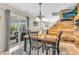 Dining area with hardwood accent wall, modern lighting, and sliding door access to an outdoor lounge at 3637 Newberry Rd, Plainfield, IN 46168