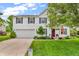 Attractive two-story home with a well-manicured lawn, garage, and 'Hello Spring' sign at 3637 Newberry Rd, Plainfield, IN 46168