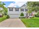 Charming two-story home featuring a well-manicured lawn and an attached two-car garage at 3637 Newberry Rd, Plainfield, IN 46168
