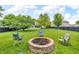 Relaxing backyard featuring a brick fire pit and chairs, ideal for entertaining outdoors at 3637 Newberry Rd, Plainfield, IN 46168