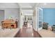 Inviting foyer with hardwood floors, piano, and view into the living room at 3637 Newberry Rd, Plainfield, IN 46168