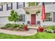 Charming front porch with potted plants, seating, and a welcoming American flag at 3637 Newberry Rd, Plainfield, IN 46168