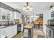 Bright kitchen with island, modern appliances, and charming brick accent wall leading to an open dining area at 3637 Newberry Rd, Plainfield, IN 46168
