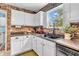 Functional kitchen featuring white cabinets, brick backsplash, and sleek appliances at 3637 Newberry Rd, Plainfield, IN 46168