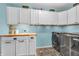 Bright laundry room featuring built-in cabinets, and modern appliances at 3637 Newberry Rd, Plainfield, IN 46168