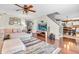 Open-concept living room with hardwood floors, a large TV, and inviting furniture at 3637 Newberry Rd, Plainfield, IN 46168