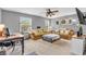 Spacious living room with two sofas, soft carpet, and large windows providing ample natural light at 3637 Newberry Rd, Plainfield, IN 46168
