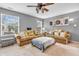 Cozy living room featuring a ceiling fan, comfortable seating, and large windows with bright natural light at 3637 Newberry Rd, Plainfield, IN 46168