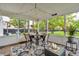 Inviting screened porch with a dining table, comfortable seating, and views of the landscaped backyard at 3637 Newberry Rd, Plainfield, IN 46168