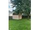 Backyard featuring a large shade tree, a storage shed, green grass, and a wooden privacy fence at 39 Meadow Creek East Blvd, Whiteland, IN 46184