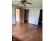 Spacious bedroom featuring laminate wood flooring, a ceiling fan, and multiple closets and doors for ample storage at 39 Meadow Creek East Blvd, Whiteland, IN 46184