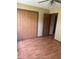 Bedroom featuring laminate wood flooring, a ceiling fan, closet and multiple doors for ample storage and easy access at 39 Meadow Creek East Blvd, Whiteland, IN 46184