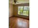 Bedroom with bright natural light through a large window, laminate flooring, and a ceiling fan at 39 Meadow Creek East Blvd, Whiteland, IN 46184