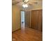 Bedroom featuring laminate wood flooring, a ceiling fan, closet and multiple doors for ample storage and easy access at 39 Meadow Creek East Blvd, Whiteland, IN 46184